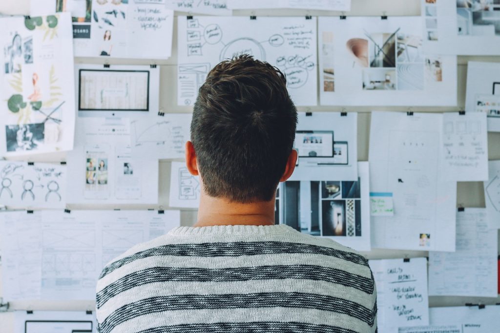 A Man looking at drawing board